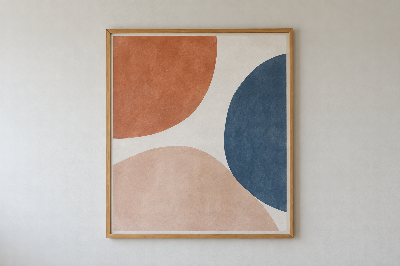 Gerahmtes abstraktes Bild mit terracottafarbenen, blauen und hellrosa Rundformen an einer hellen Wand.
